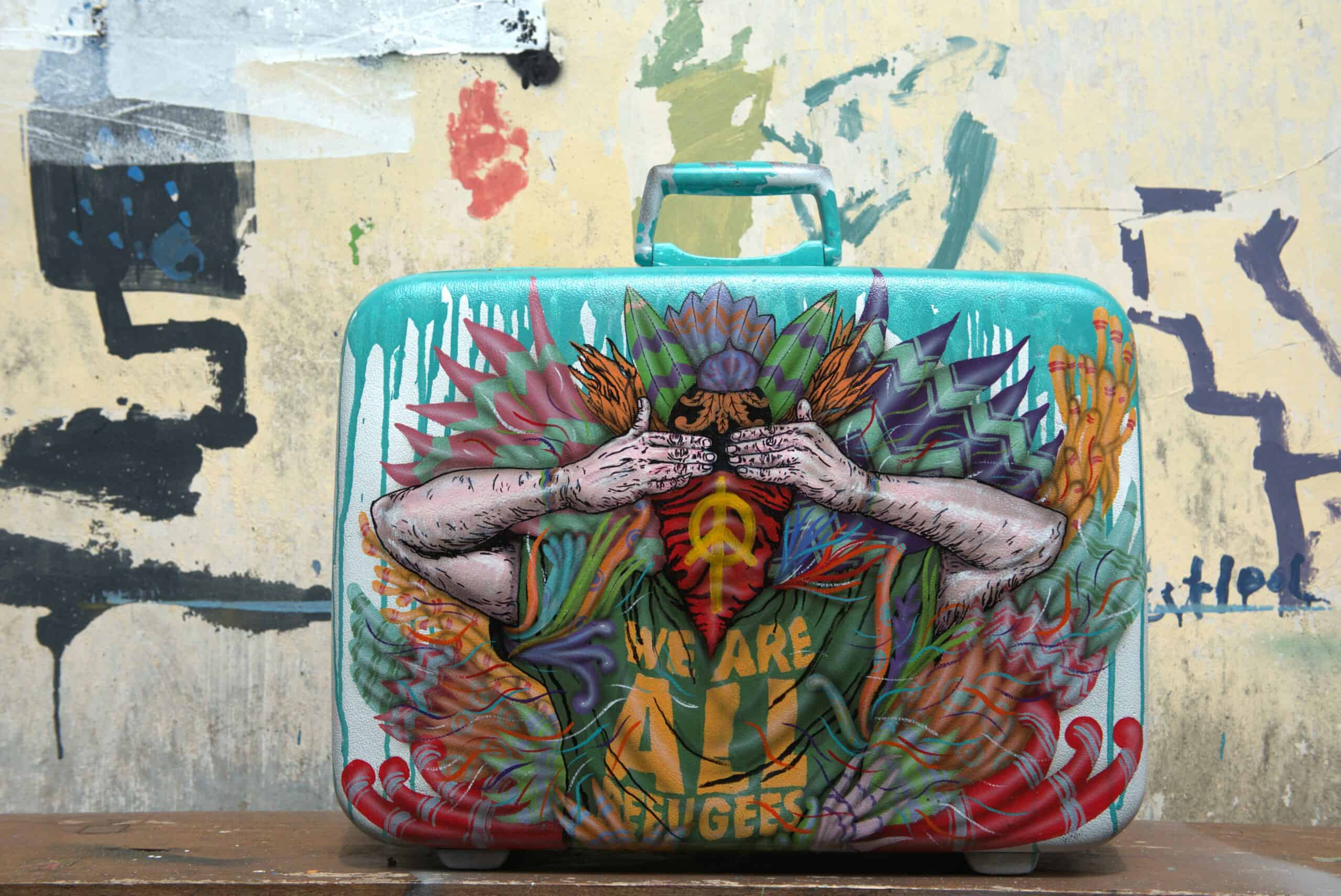 We are All Refugees (2024), Spray paint stencil on suitcase, 38 x 52 x 12cm